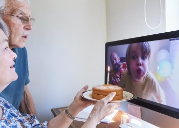 Family celebrating a birthday together via video call