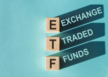 Tile letter on red rack in word ETF (abbreviation of Exchange Traded Fund) on wood background