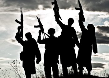 Silhouette of several militants with rifles