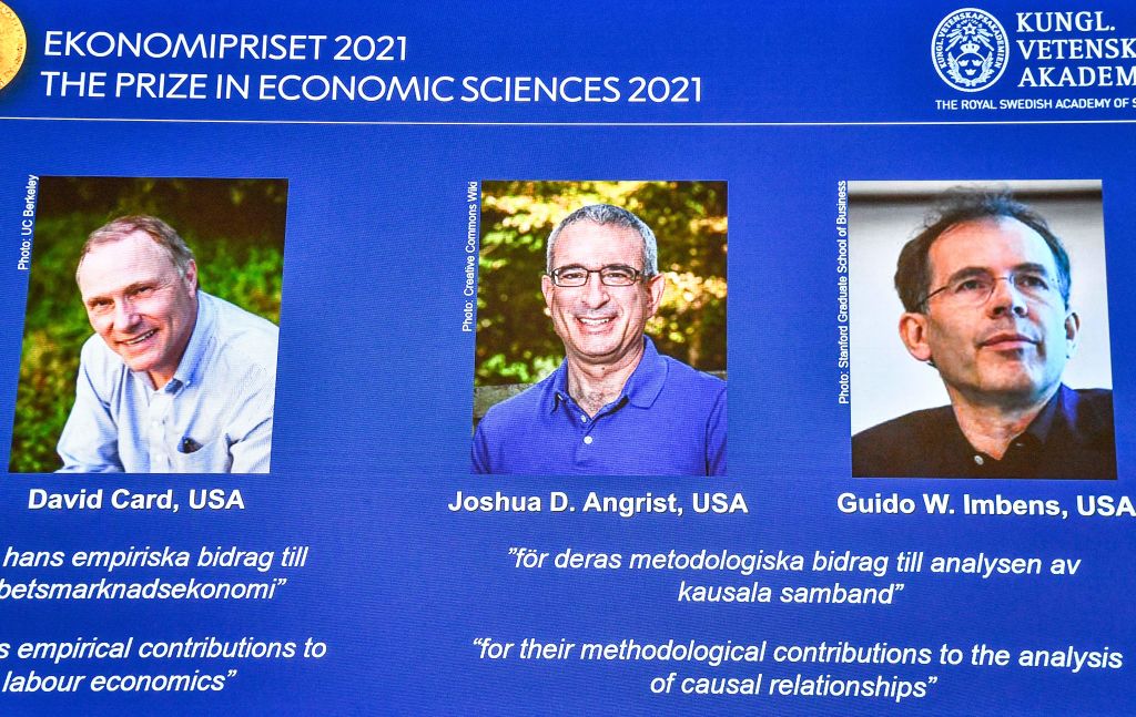 The winners of the 2021 Sveriges Riksbank Prize in Economic Sciences in Memory of Alfred Nobel (L-R) David Card from the University of California, Berkeley, USA, Joshua D. Angrist from the Massachusetts Institute of Technology, Cambridge, USA and Guido W. Imbens from the Stanford University, USA, are seen on a screen during a press conference at the Royal Swedish Academy of Sciences in Stockholm, Sweden, on October 11, 2021. - Canadian David Card, Israeli-American Joshua Angrist and Dutch-American Guido Imbens won the Nobel Economics Prize for insights into the labour market and "natural experiments", the jury said. - Sweden OUT (Photo by Claudio BRESCIANI / TT NEWS AGENCY / AFP) / Sweden OUT (Photo by CLAUDIO BRESCIANI/TT NEWS AGENCY/AFP via Getty Images)