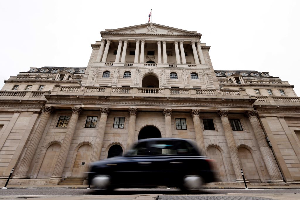 A black cab goes past the Bank of England in London on December 16, 2021. - The Bank of England hiked its key interest rate from 0.10 percent to 0.25 percent, as it seeks to combat decade-high inflation despite Omicron concerns. (Photo by Tolga Akmen / AFP) (Photo by TOLGA AKMEN/AFP via Getty Images)