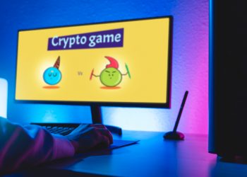 Gamer playing online blockchain game on computer - Crypto, nft, token currency concept - Focus on hand