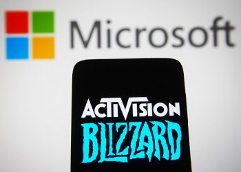 UKRAINE - 2022/01/18: In this photo illustration, the Activision Blizzard logo is seen displayed on a smartphone screen with the Microsoft Corporation logo in the background. (Photo Illustration by Pavlo Gonchar/SOPA Images/LightRocket via Getty Images)