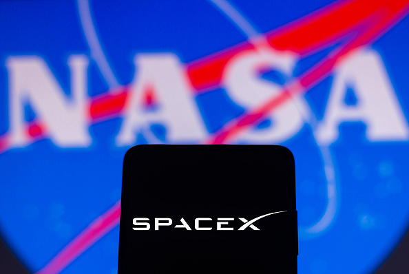 In this photo illustration a SpaceX is displayed on a