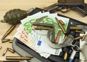 Internet illegal arms trade. Merchant arrest illegal ammunition. Internet crime. Current euro banknotes and Czech koruna.