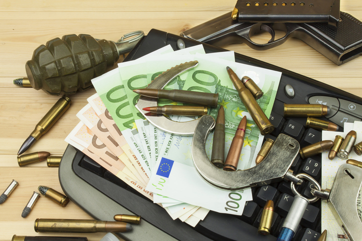 Internet illegal arms trade. Merchant arrest illegal ammunition. Internet crime. Current euro banknotes and Czech koruna.