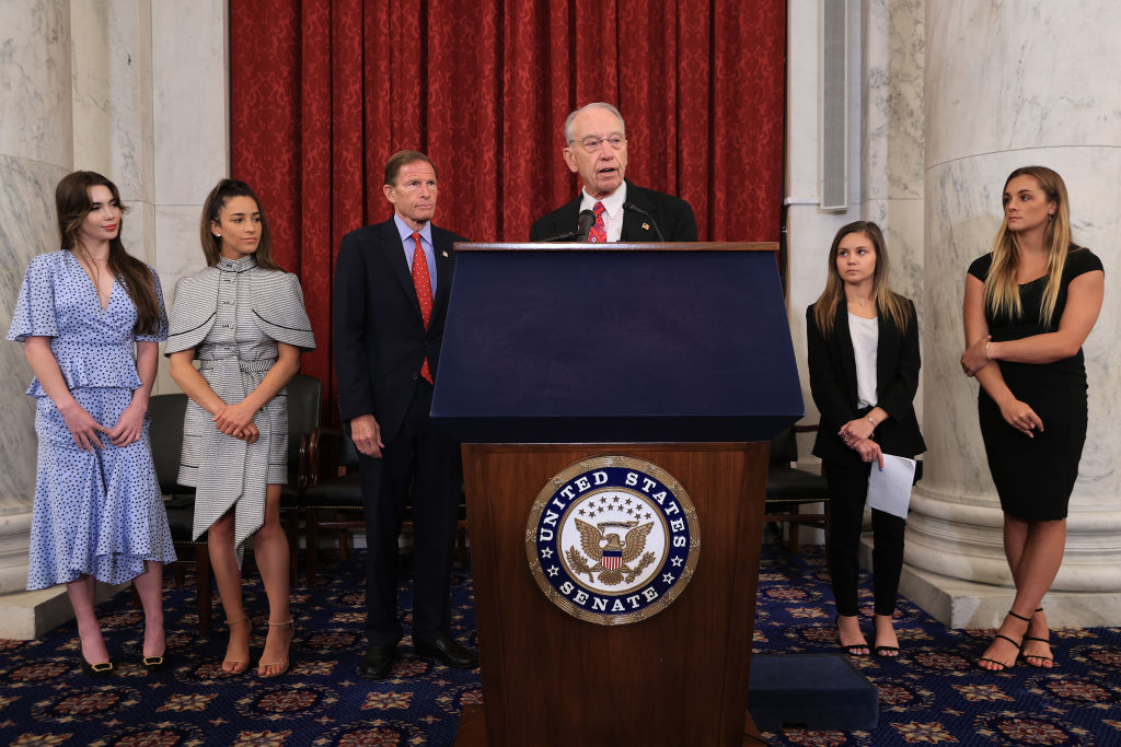 WASHINGTON, DC - SEPTEMBER 15: (L-R) Former U.S. Olympic gymnast McKayla Maroney, national champion Jessica Howard, Olympian Aly Raismam, Sen. Richard Blumenthal (D-CT), Sen. Charles Grassley (R-IA), gymnast Kaylee Lorincz and NCAA and world champion gymnast Maggie Nichols hold a news conference in the Russell Senate Office Building following the gymnasts' testimony before the Senate Judiciary Committee on September 15, 2021 in Washington, DC. Maroney, Raisman and Nichols testified about the abuse they experienced at the hands of Larry Nassar, the now-imprisoned U.S. women's national gymnastics team doctor, and the Federal Bureau of Investigation’s lack of urgency when handling their cases. (Photo by Chip Somodevilla/Getty Images)
