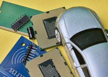 CPU chip and semiconductors with car toy. Global car chip shortage. Micro-chip shortage creates dearth of new cars. Computer chip shortage stalls car industry production