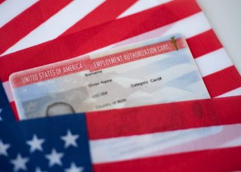 Employment Authorization card on USA Flag surface. Close up view.