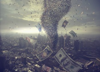 Tornado of money over cityscape