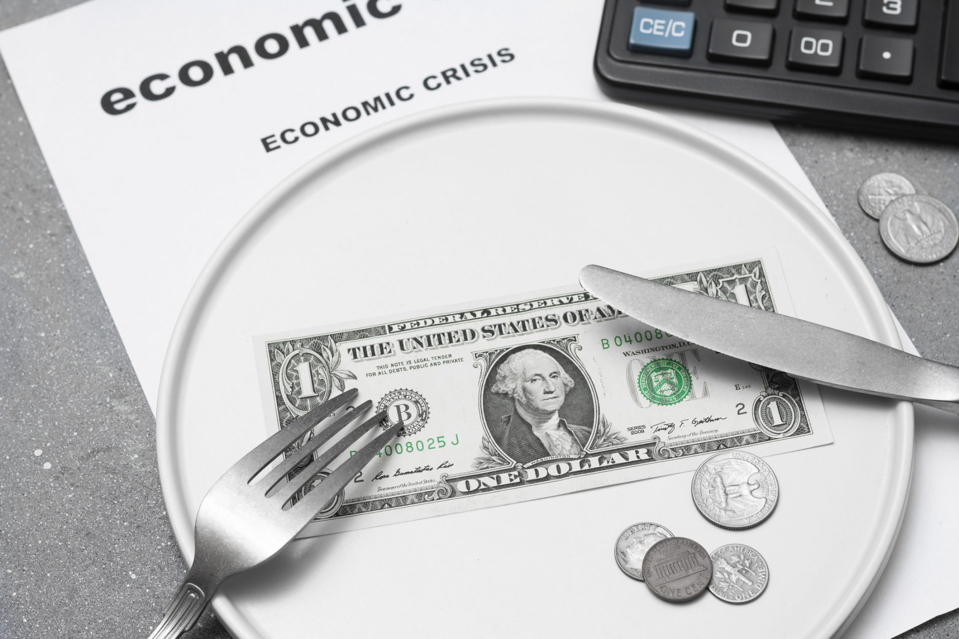 Economic crisis. One paper dollar with a fork and knife on a white plate Dividing the budget. Concept of the global financial crisis. Lack of money for food.