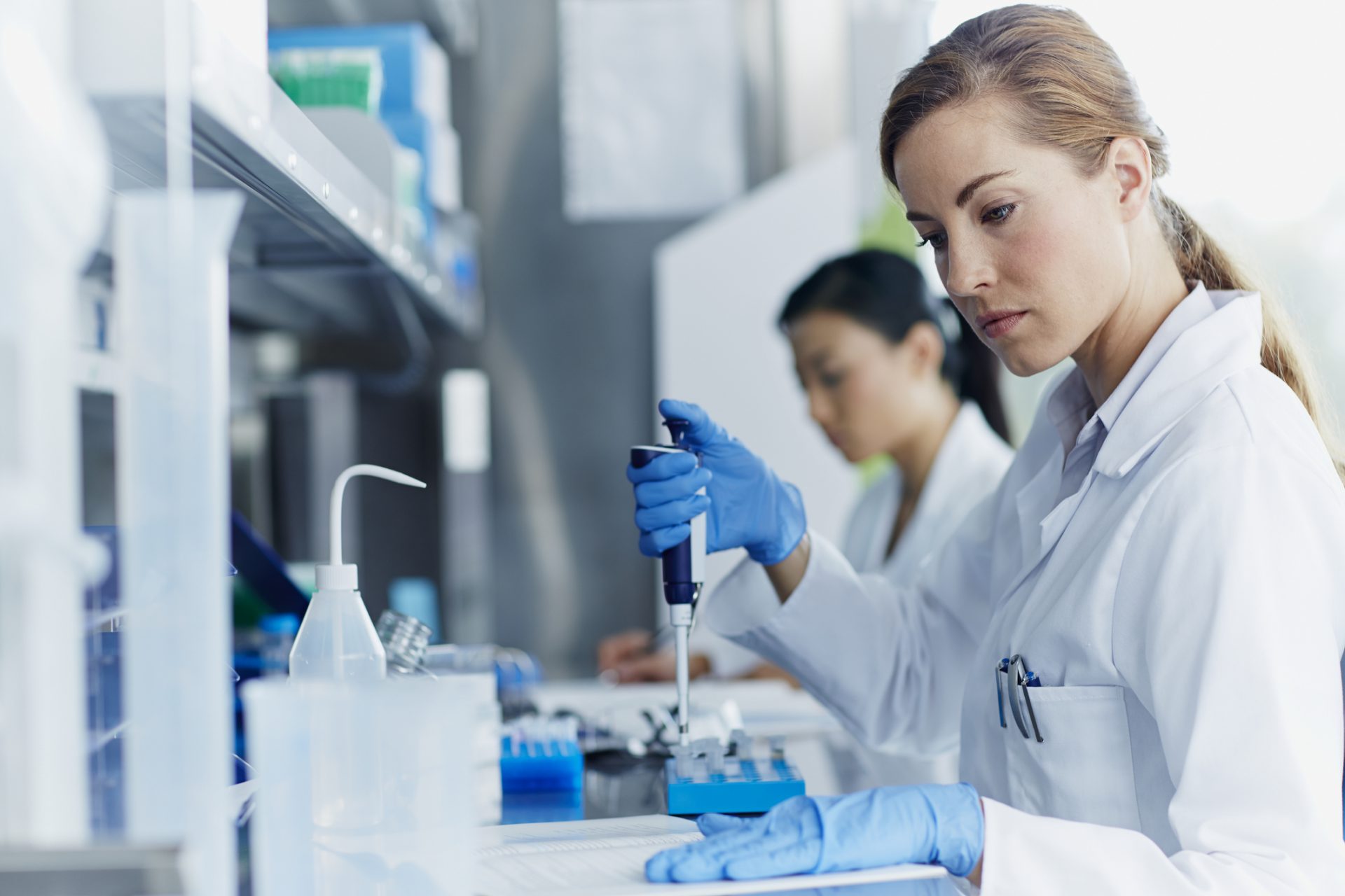 Female scientists working in modern biotechnology laboratory