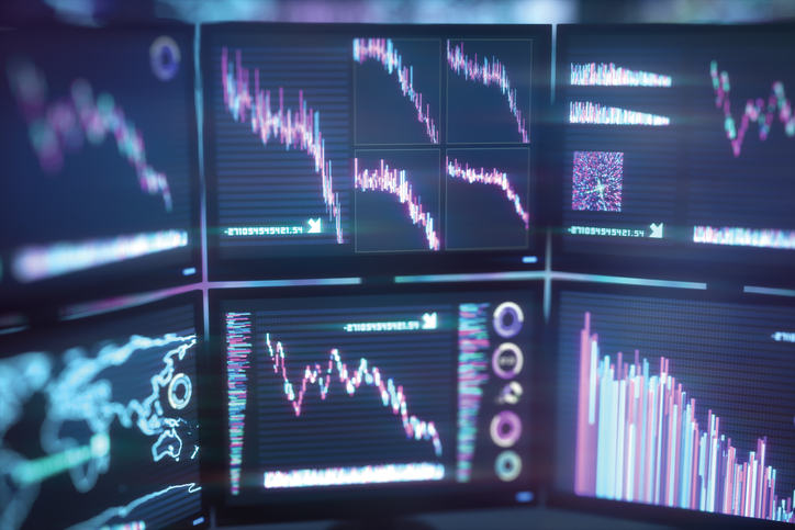 Illustration of computer monitors showing falling stock markets. Computer generated image.