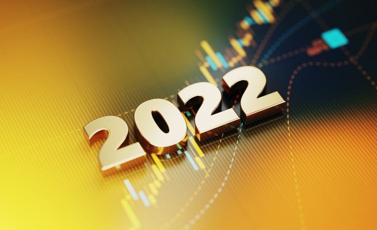 Gold colored 2022 sitting on yellow financial graph background. Horizontal composition with selective focus and copy space. Investment, stock market data and finance concept.