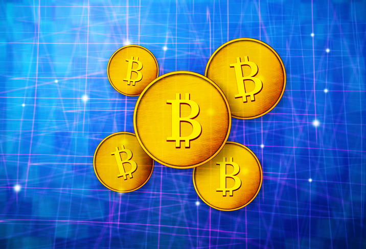 5 variously sized Bitcoins on abstract blue background