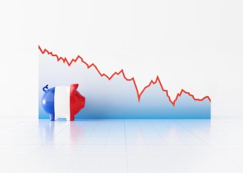 Piggy bank textured with French flag sitting in front of a line graph on white background. Horizontal composition with copy space. Volatility in French Economy and Euro.