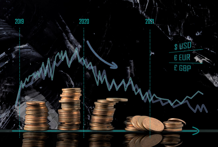 Coin stacks and receding economy graphs. Conceptual image of the economical situation and possible upcoming crisis in 2020.