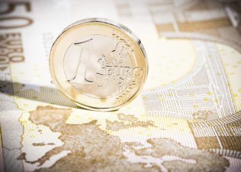 A clean 1 Euro coin reflecting the map of Europe printed on the 50 Euro banknote.