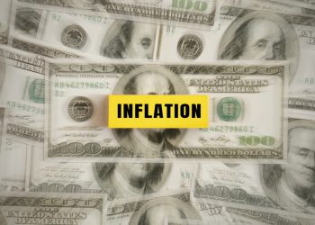inflation text on a yellow wooden block placed on a dollar bill. The idea for FED considers interest rate hikes, world economics, and inflation control, Concept shows rising inflation.