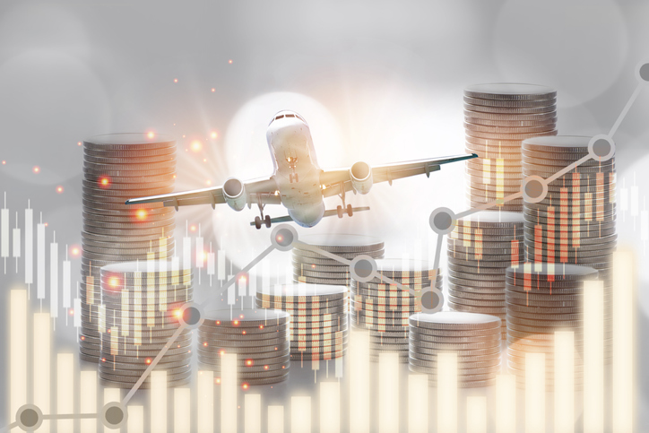 Stack of coins and growth graph on aircraft transportation background