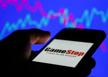 GameStop logo displayed on a phone screen and a illustrative stock chart on the background are seen in this illustration photo taken in Poland on January 31, 2021. (Photo Illustration by Jakub Porzycki/NurPhoto via Getty Images)
