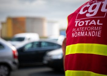 A protester participates in CGT trade unionists and employees gathering beside the Total Energy raffinery site, in Gonfreville-l'Orcher, near Le Havre, northwestern France, on October 10, 2022. - A hundred employees voted on October 6, to continue the strike for wages at the TotalEnergies platform in Normandy, Gonfreville-L'Orcher, while tension is increasing in the service stations. (Photo by Lou BENOIST / AFP) (Photo by LOU BENOIST/AFP via Getty Images)