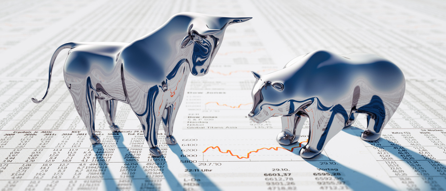 Silver Bull and Bear standing on a financial Newspaper with Charts