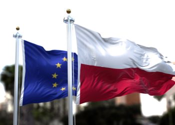 The flags of Poland and the European Union waving in the wind. On October 2021 polish Constitutional Tribunal issued that the Polish Constitution in some cases supersedes rulings by the EU court.