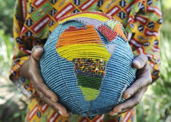 Woman holding a beaded globe with africa showing