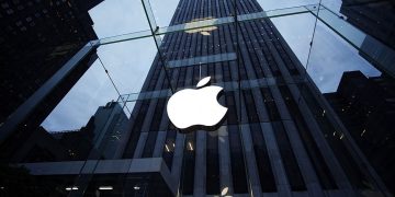 "New York City, USA - June 12, 2012: Glass entrance of the Apple Store at 5th Avenue near Central Park with Apple Logo."