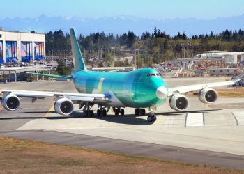 Everett, Washington, USA - July 31, 2017 - Boeing 4-engine double deck 747 jet airplane being tested on the runway at the Boeing factory located in Everett, Washington USA. The planes in production are wrapped in green coating.