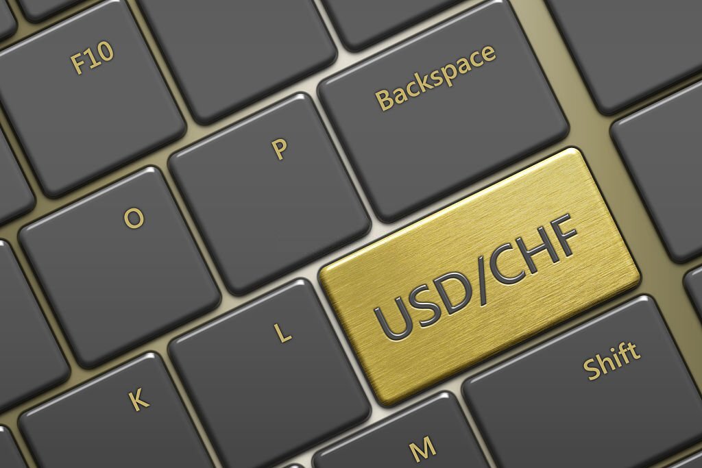 closeup of computer keyboard with currency pair: usd/chf button
