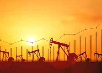 Up trend line graph and Silhouette Oil pumps at oil field with sunset sky background