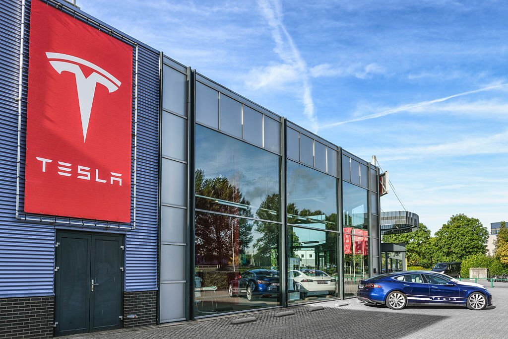 Duiven, The Netherlands - September 10, 2015: Blue and white Tesla Model S full electric luxury car parked outside a dealership.