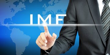 Businessman hand pointing to IMF (International Monetary Fund) sign on virtual sceen