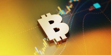 Gold colored Bitcoin symbol sitting on yellow financial graph background. Horizontal composition with selective focus and copy space. Investment, stock market data and finance concept.